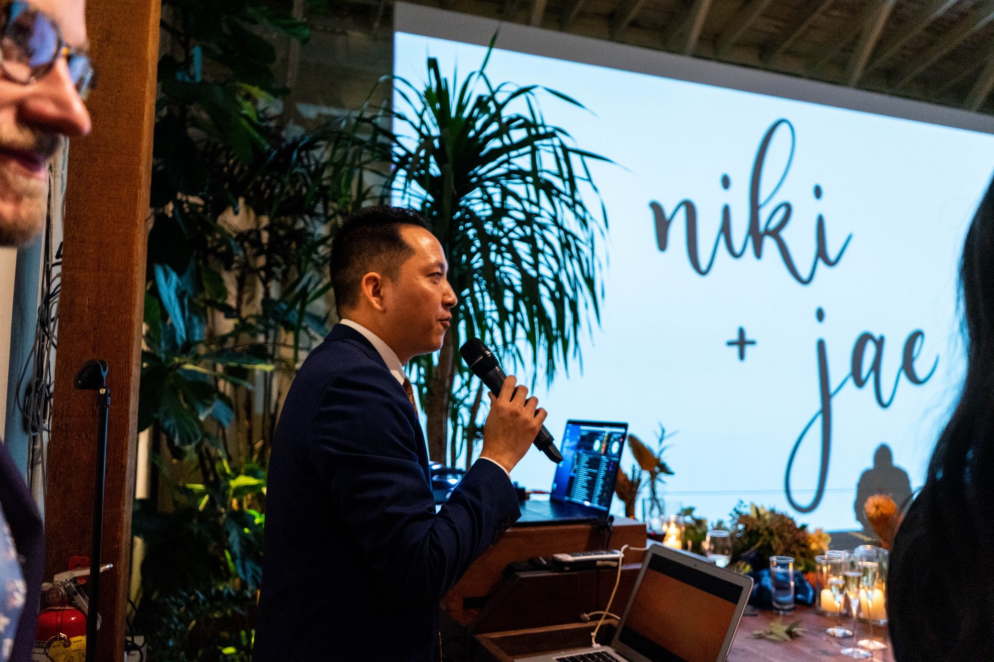 DJ Logos on the mic at a reception