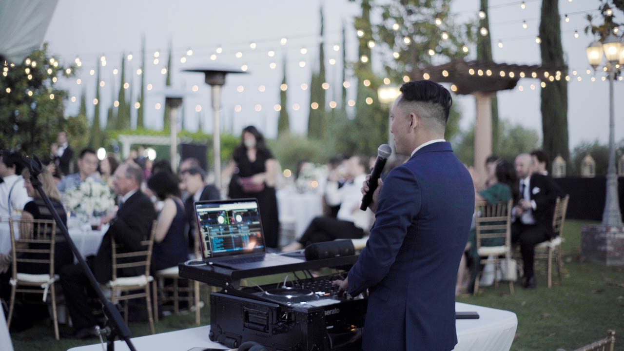 DJ Logos performing at an outdoor reception