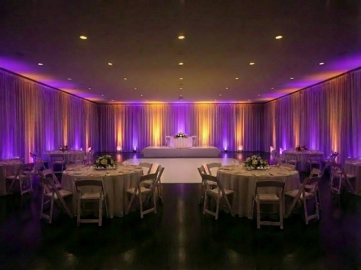 Ballroom after uplighting transformation — purple and gold wall wash