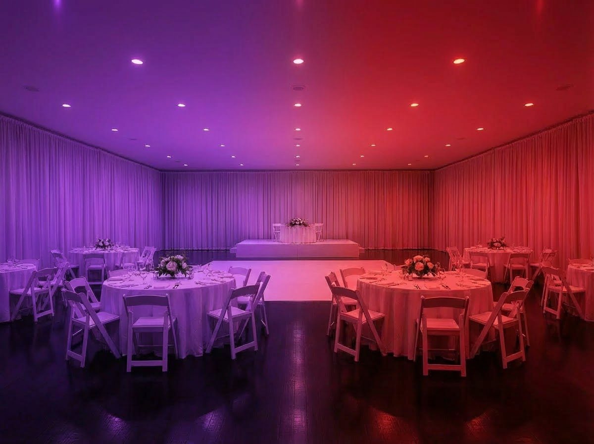 Ballroom after wash lighting — broad purple-to-red color wash filling the room