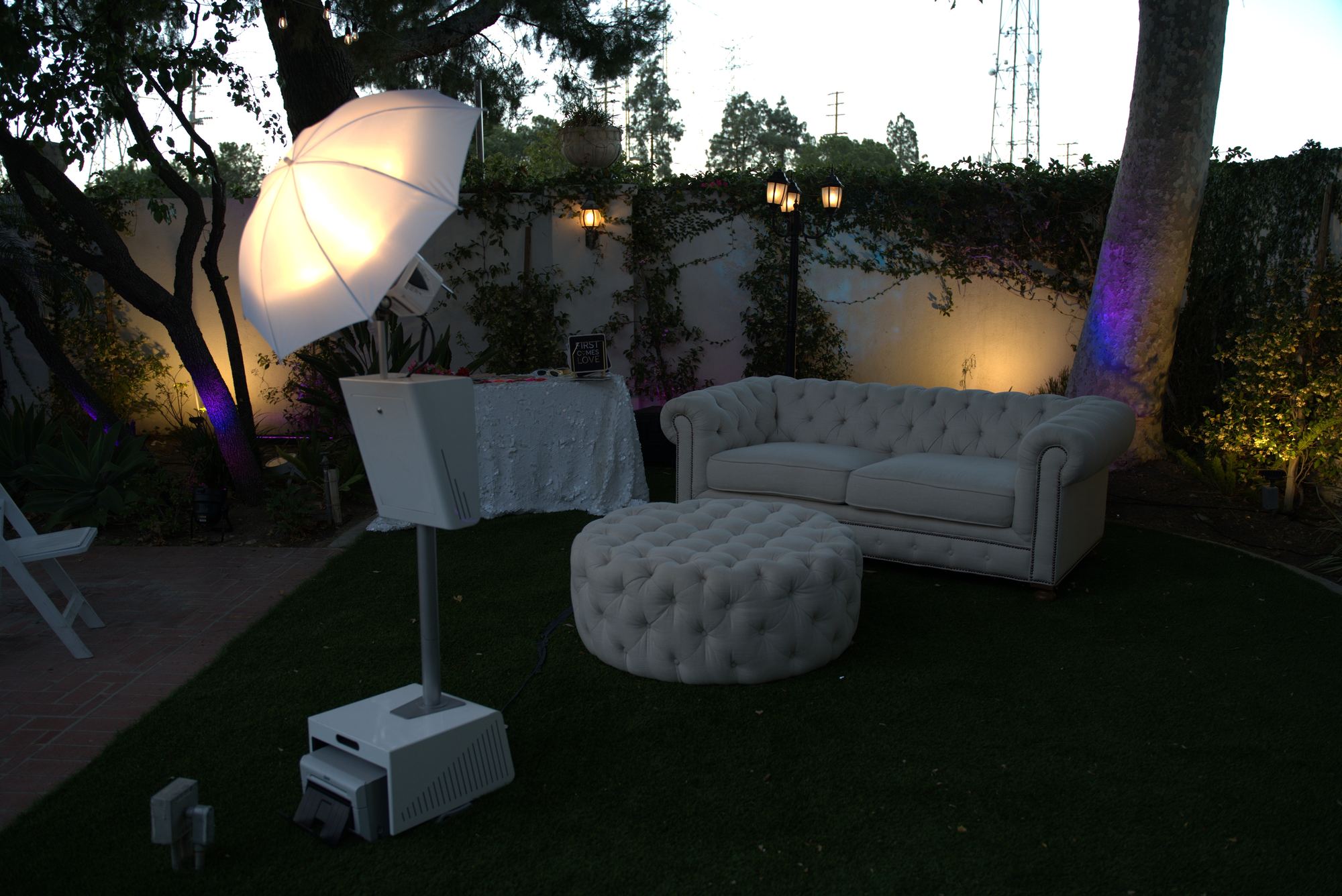 Classic luxury photobooth set up in an elegant outdoor lounge at a wedding