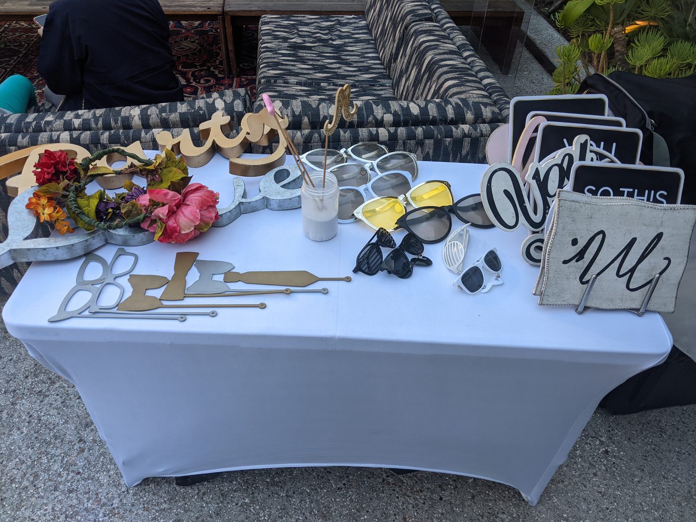 Photobooth prop table with mustache cutouts and fun sign props at an event