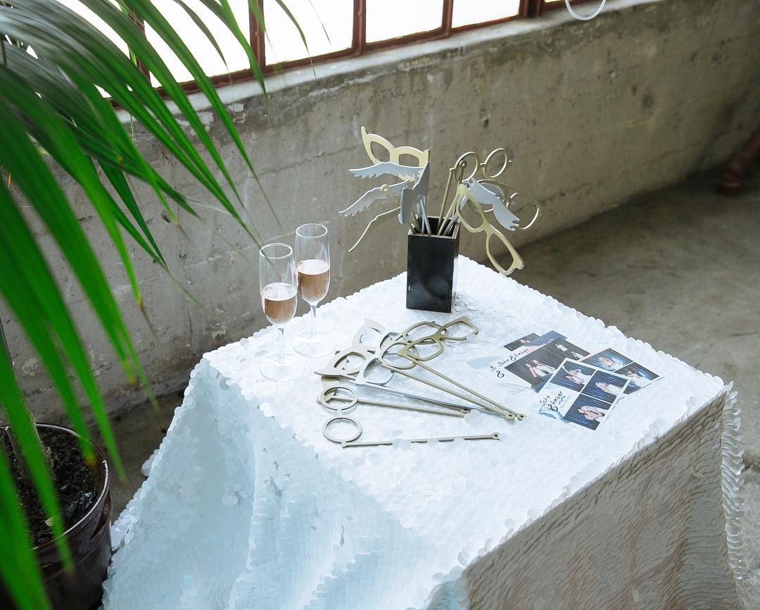 Photobooth prop table with sunglasses and tiara props on an outdoor patio