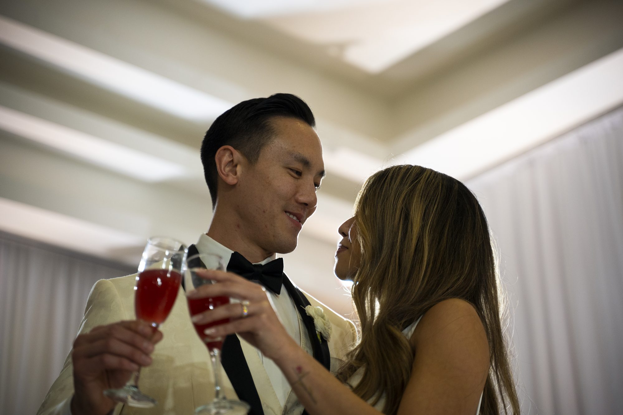 Bride and groom sharing a toast at their Lotus Event Pros wedding reception